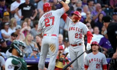 Los Angeles Angels' Mike Trout (27) celebrates after his solo home run with Brandon Drury (23).