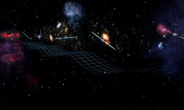 An artist's rendering of gravitational waves from a pair of close-orbiting black holes (visible on the left in the distance). The waves are passing by several pulsars and Earth (on the right).