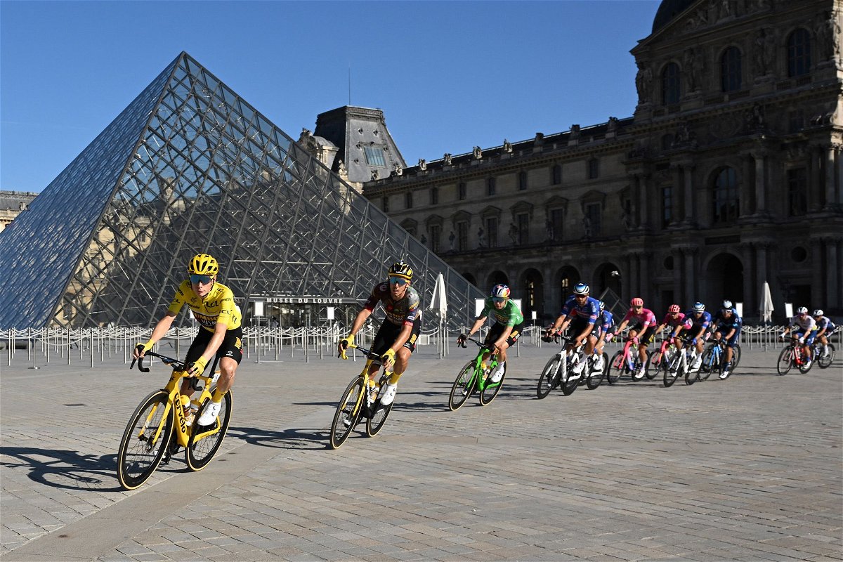<i>Bertrand Guay/Reuters</i><br/>Jonas Vingegaard in action with riders passing the Louvre museum in Paris during the 2022 Tour de France.