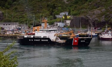A U.S. Coast Guard ship arrives in the harbor of St. John's