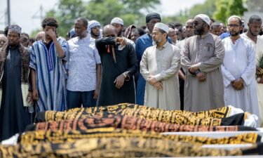 Men mourn the five women killed in a car crash