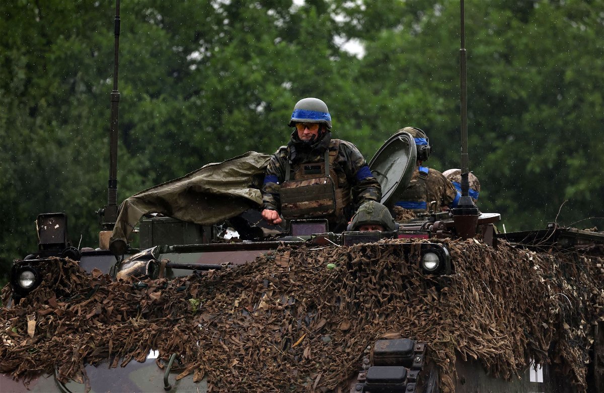 <i>Anatolii Stepanov/AFP/Getty Images</i><br/>Ukrainian troops ride atop an armored personnel carrier vehicle in the Zaporizhzhia region on June 11.