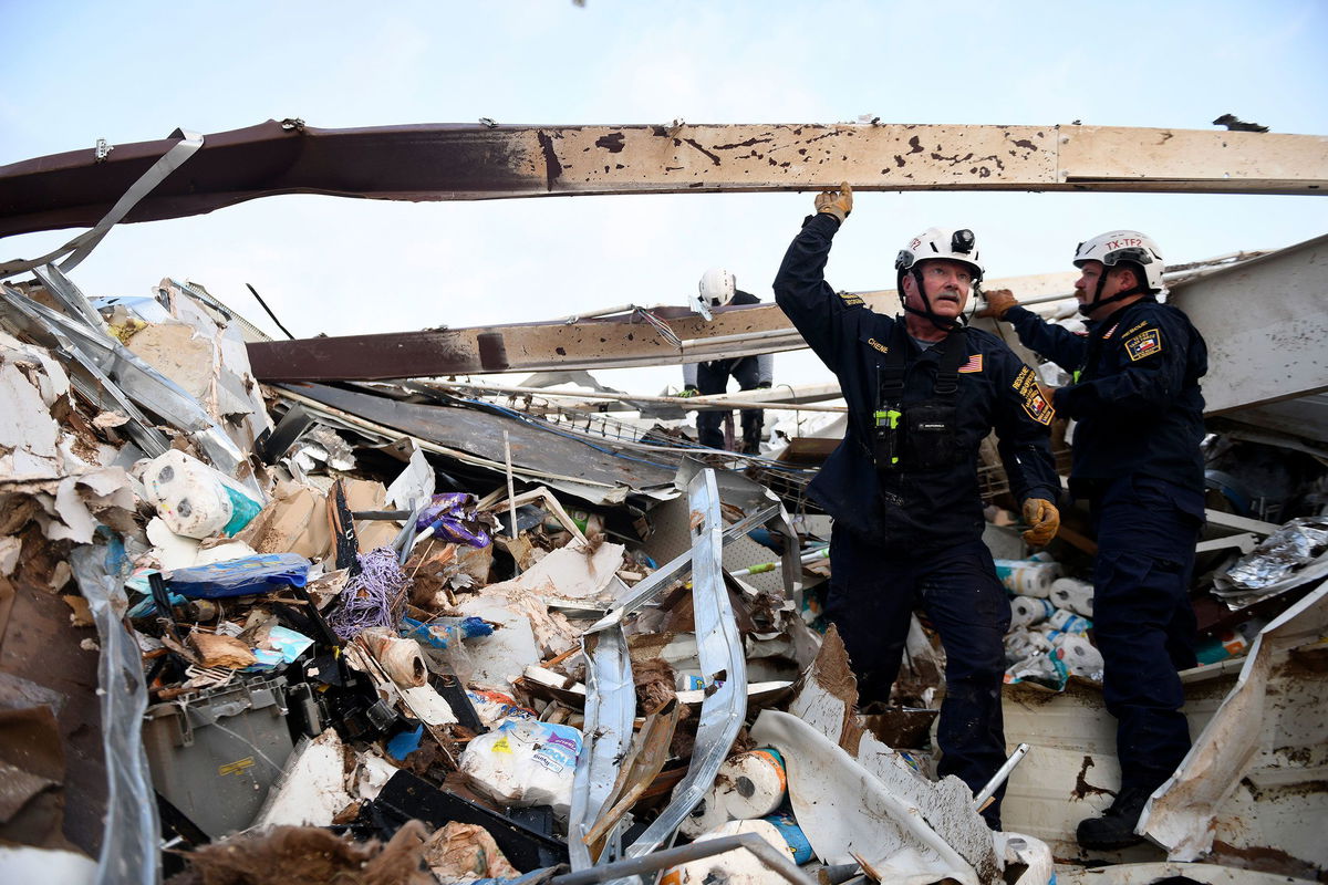 <i>Annie Rice/Lubbock Avalanche-Journal/AP</i><br/>Search and rescue teams look for survivors in a former Dollar General after a tornado in Matador