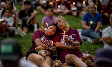 Families participate in a candlelight vigil in Uvalde dedicated to the victims on May 24
