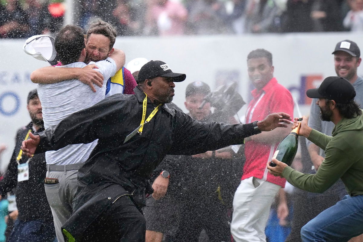 <i>Nathan Denette/AP</i><br/>A security guard stops Hadwin as Taylor celebrates.