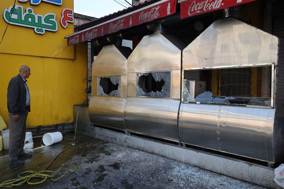 <i>Jaafar Ashtiyeh/AFP/Getty Images</i><br/>A man inspects the damage to a restaurant following a reported attack by Israeli settlers in Huwara on March 28.