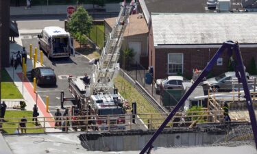 Firefighters rescue a worker after the partial collapse of a building under construction on June 2 in New Haven.