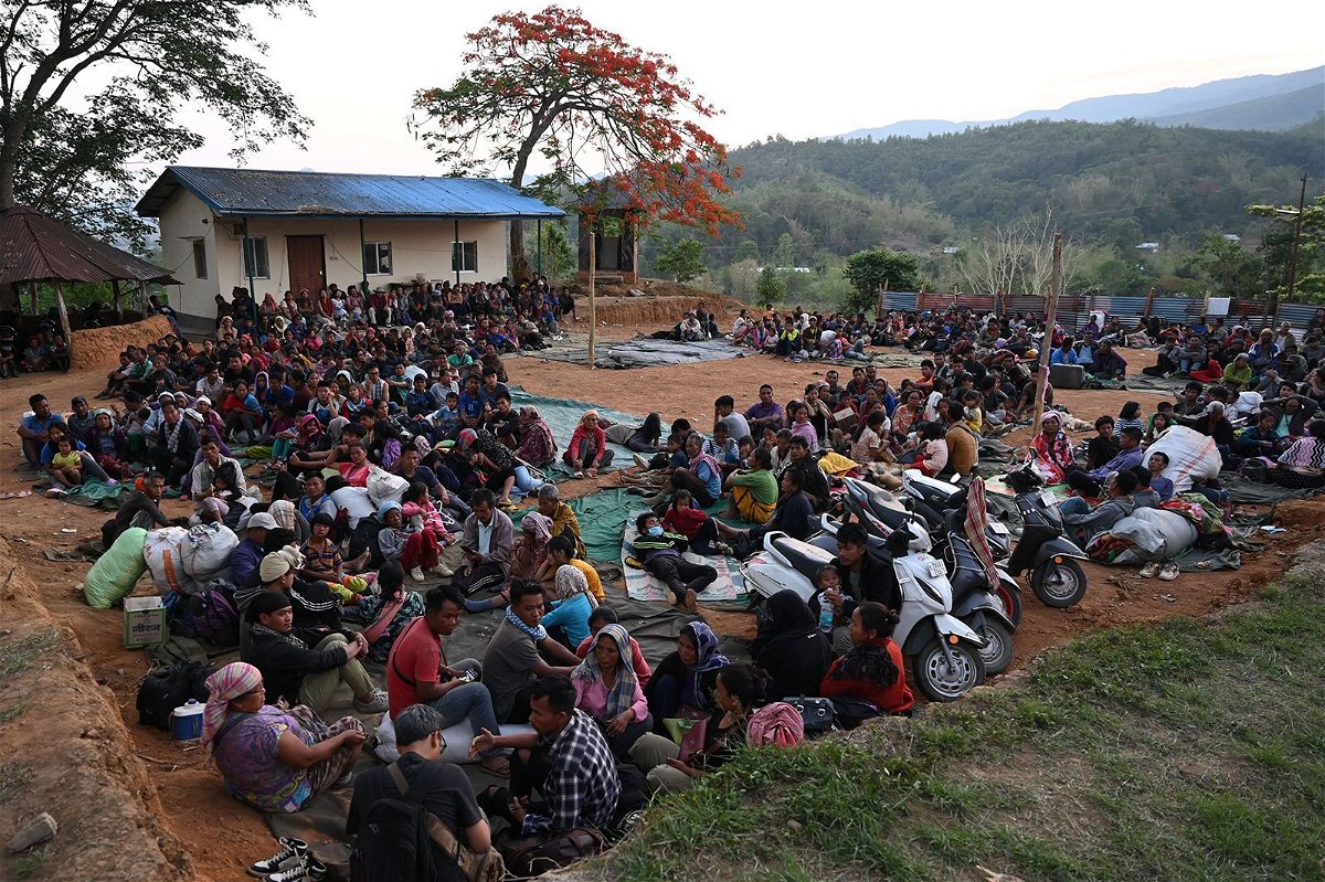 <i>Arun Sankar/AFP/Getty Images</i><br/>People wait at a temporary shelter in a military camp on May 7