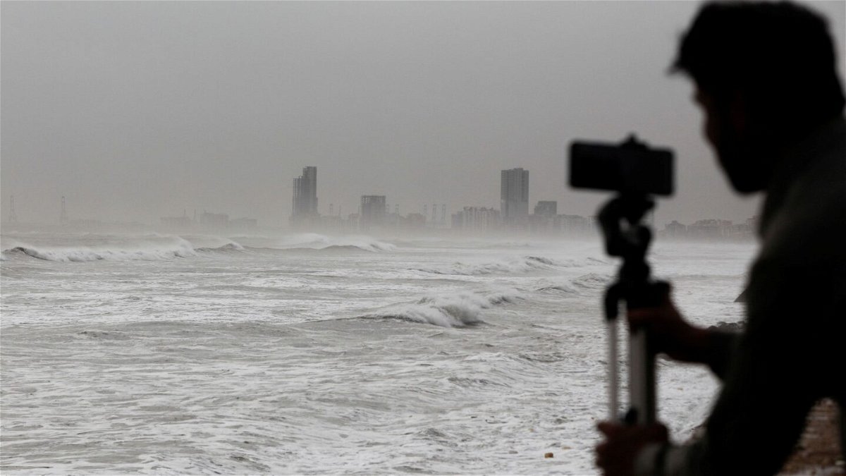 <i>Akhtar Soomro/Reuters</i><br/>A man films the sea