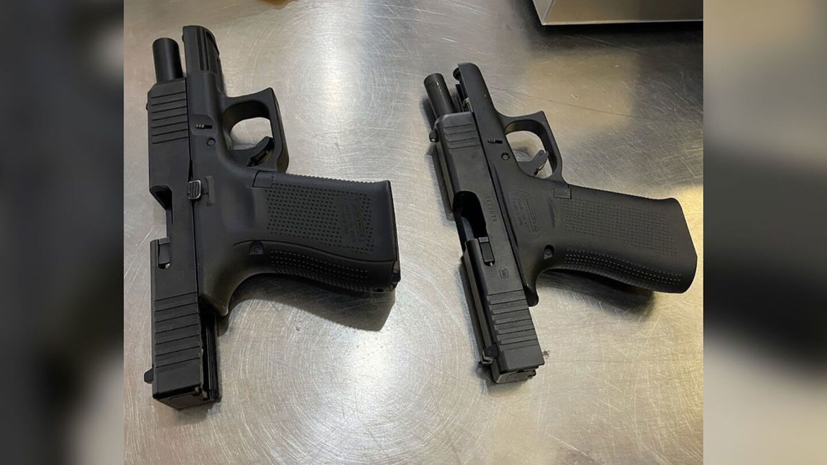 <i>TSA</i><br/>A photo from the TSA shows two loaded firearms found in the carry-on luggage of a male passenger.