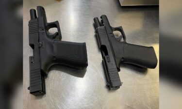 A photo from the TSA shows two loaded firearms found in the carry-on luggage of a male passenger.