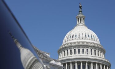 The dome of the US Capitol is reflected in a window on Capitol Hill in Washington on April 20.