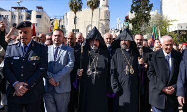 Patriarch Nurhan Manougian (C) of the Armenian Patriarchate of Jerusalem arrives to the Church of the Nativity in the occupied West Bank city of Bethlehem