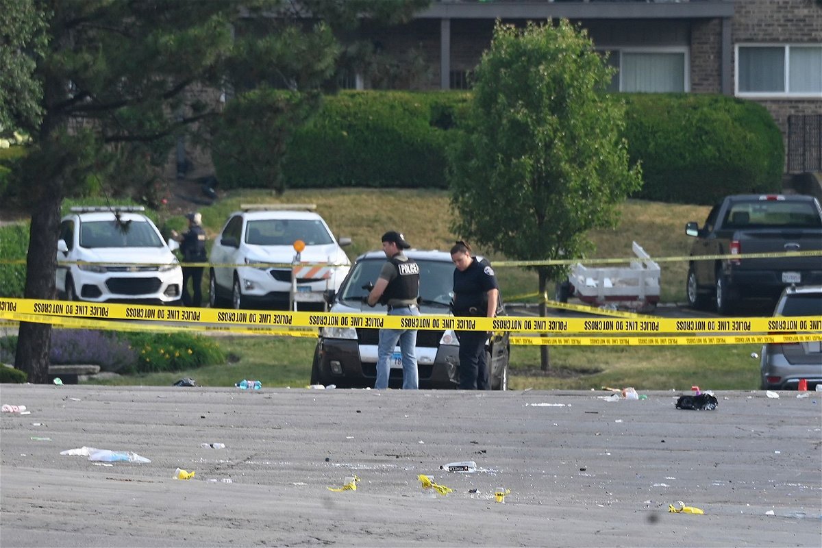 <i>Matt Marton/AP</i><br/>Investigators look over the scene of an overnight mass shooting in Willowbrook