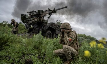 Ukrainian service members of the 55th Separate Artillery Brigade fire a Caesar self-propelled howitzer towards Russian troops