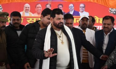 Wrestling Federation of India (WFI) president Brij Bhushan Sharan Singh (C) arrives to address a press conference in Gonda on January 20.