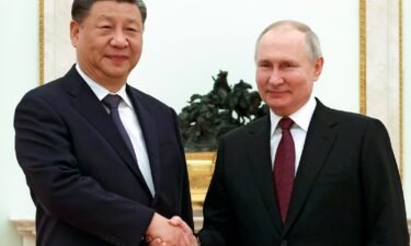 Chinese President Xi Jinping and Russian President Vladimir Putin pose for a photo during their meeting at the Kremlin in Moscow