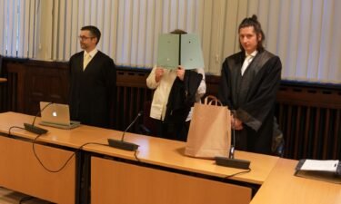 The defendant pictured standing between her lawyers at the start of her trial in January.