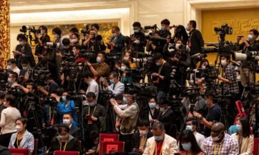 Members of the media wait ahead of the unveiling of the Communist Party of China's new Politburo Standing Committee at the Great Hall of the People in Beijing