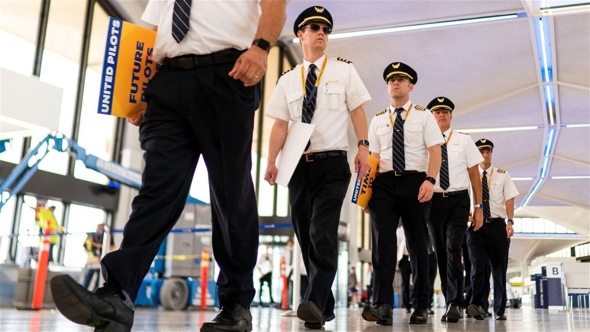 <i>Eduardo Munoz/Reuters</i><br/>Pilots from United Airlines walk inside the airport as they take part in an informational picket at Newark Liberty International Airport in Newark