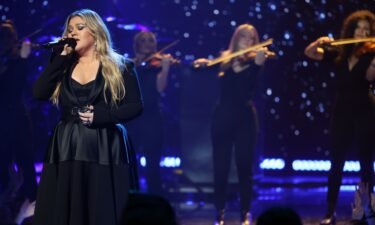 Kelly Clarkson on stage in March. Steve Martin is featured on her new album.