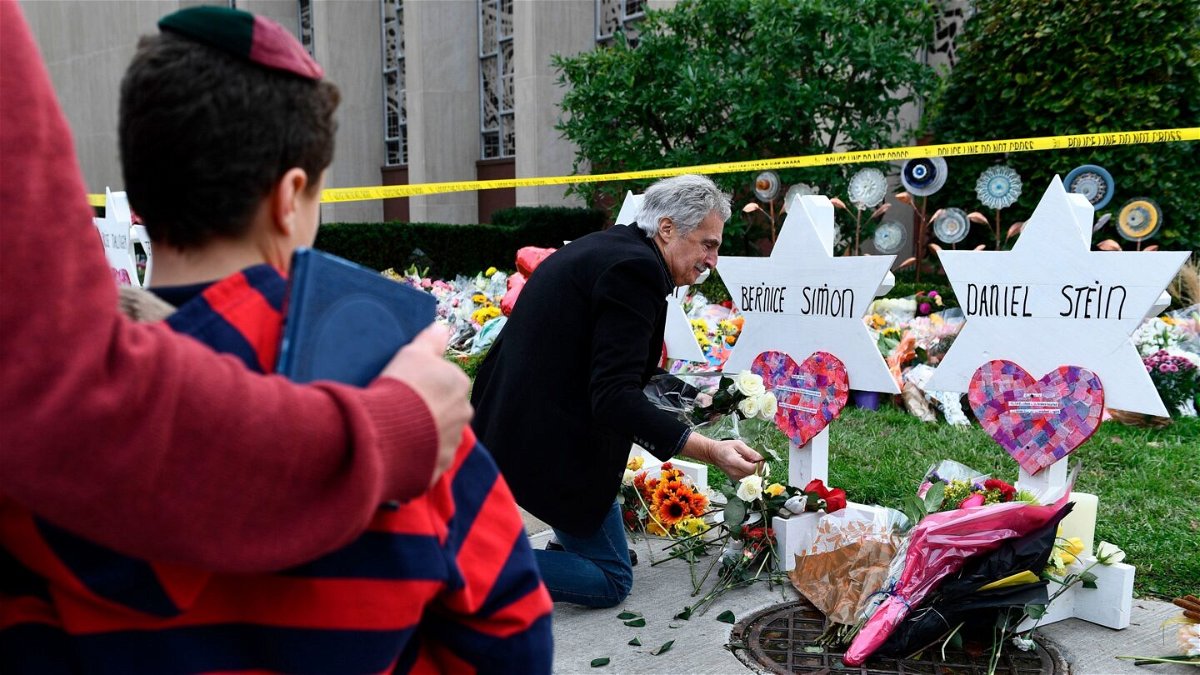 <i>Brendan Smialowski/AFP/Getty Images</i><br/>People pay their respects at a memorial outside the Tree of Life synagogue two days after the shooting.
