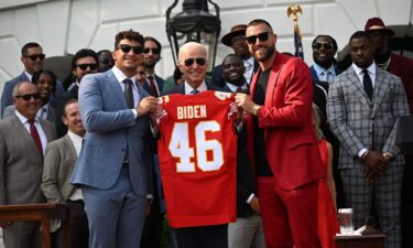 Kansas City Chiefs tight end Travis Kelce and quarterback Patrick Mahomes present President Joe Biden with a jersey during a celebration for the Kansas City Chiefs