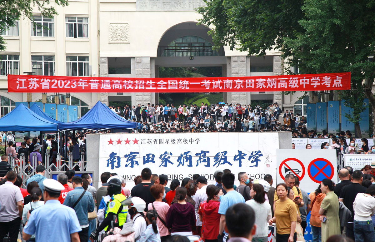 <i>Costfoto/NurPhoto/Shutterstock</i><br/>Candidates wait to enter a college entrance exam site in Nanjing