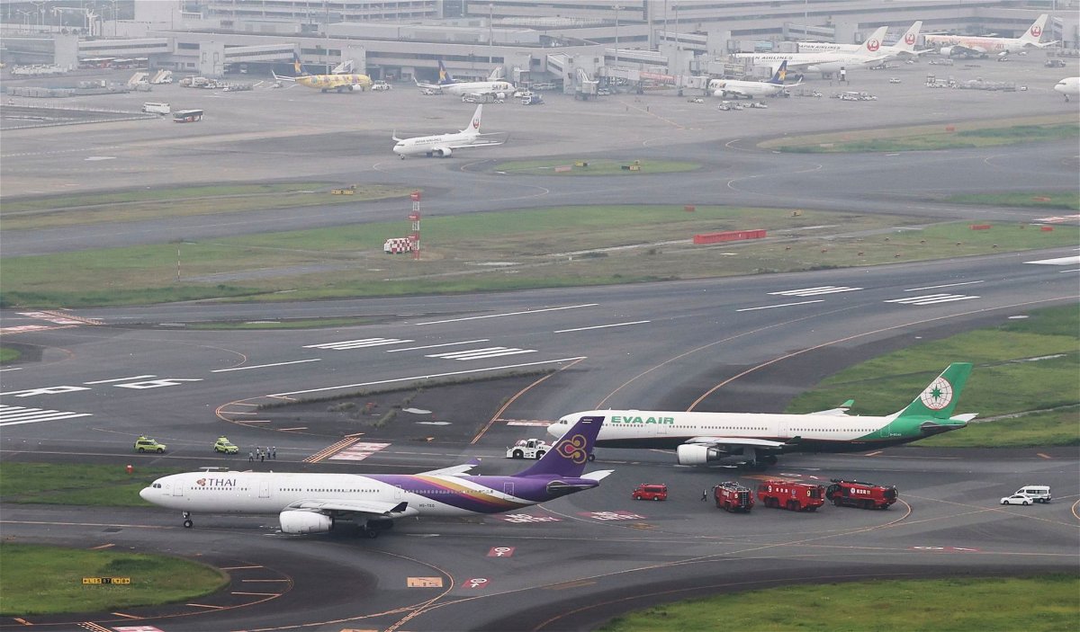 <i>Kenichi Matsuda/The Yomiuri Shimbun/AP</i><br/>Aircraft belonging to Thai Airways and Eva Air are believed to have collided on the runway at Haneda International Airport in Tokyo on June 10.