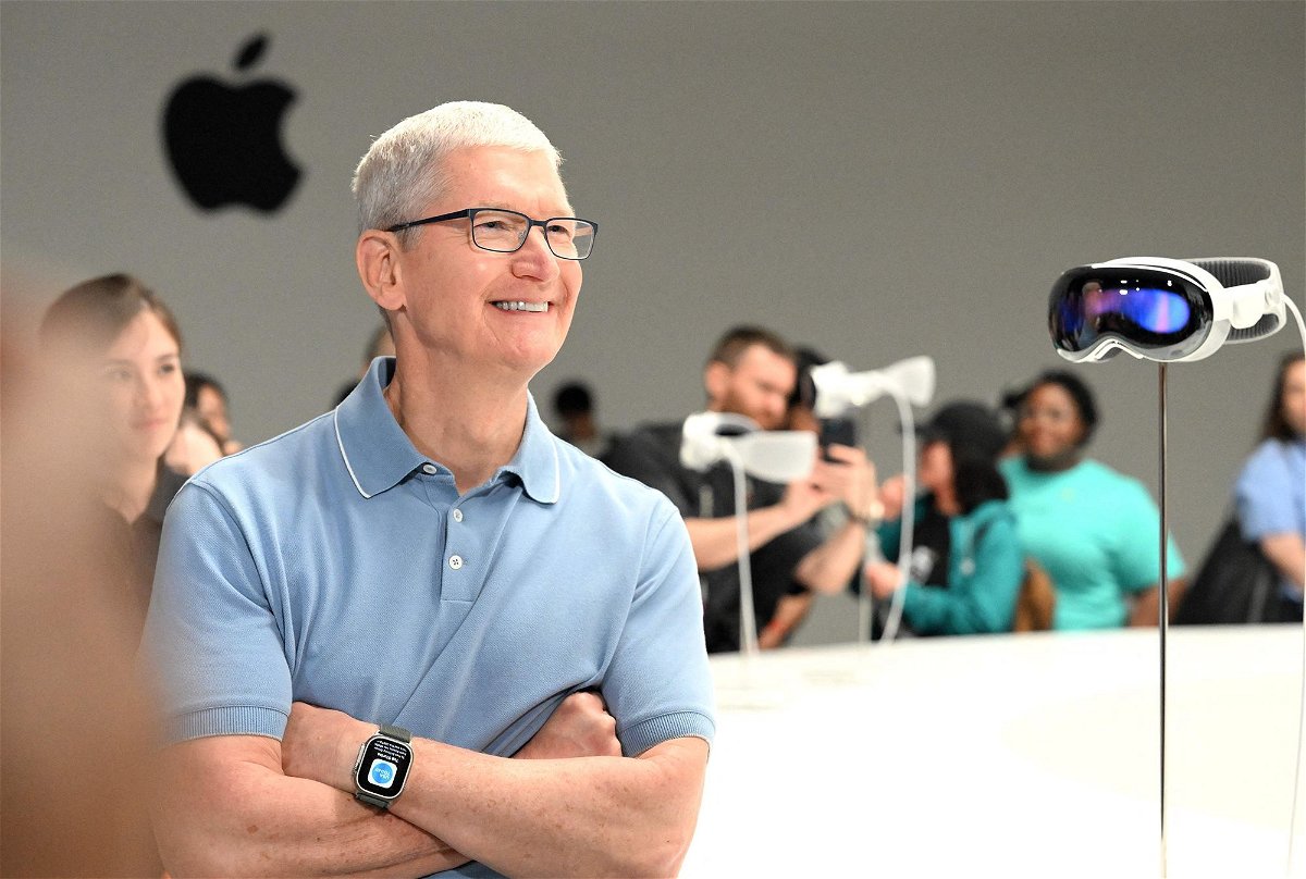 <i>Josh Edelson/AFP/Getty Images</i><br/>Apple CEO Tim Cook speaks with members of the media next to Apple's new Vision Pro virtual reality headset