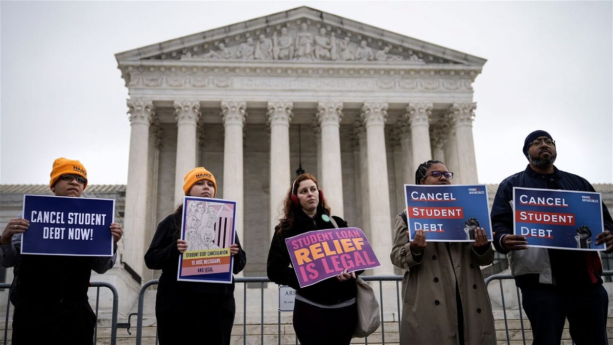 <i>Drew Angerer/Getty Images</i><br/>People rally in support of the Biden administration's student debt relief plan in front of the the U.S. Supreme Court on February 28 in Washington