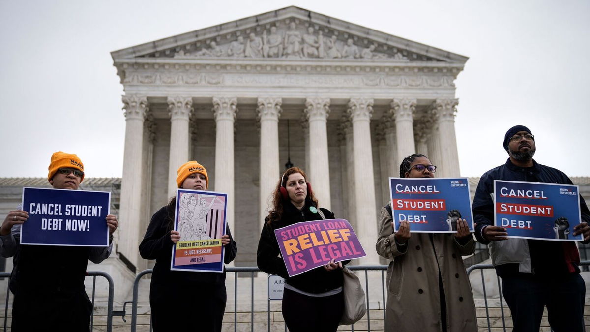 <i>Drew Angerer/Getty Images</i><br/>People rally in support of the Biden administration's student debt relief plan in front of the the U.S. Supreme Court on February 28 in Washington