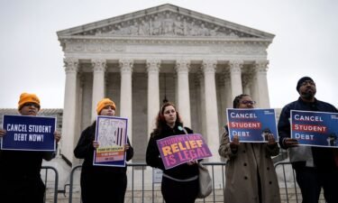 People rally in support of the Biden administration's student debt relief plan in front of the the U.S. Supreme Court on February 28 in Washington
