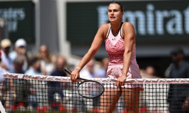 Aryna Sabalenka waits at the net after her French Open quarterfinal against Elina Svitolina