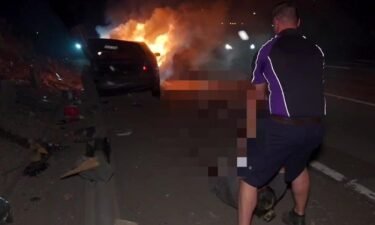 A FedEx driver pulled a driver out of a car that crashed and burst into flames on Interstate 15 on July 26.