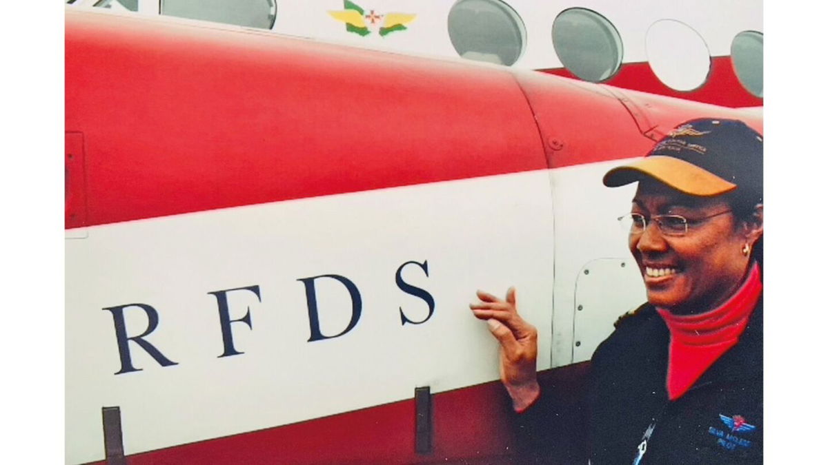 Silva McLeod in front of a Royal Flying Doctor Service plane. She worked for the RFDS as a pilot.