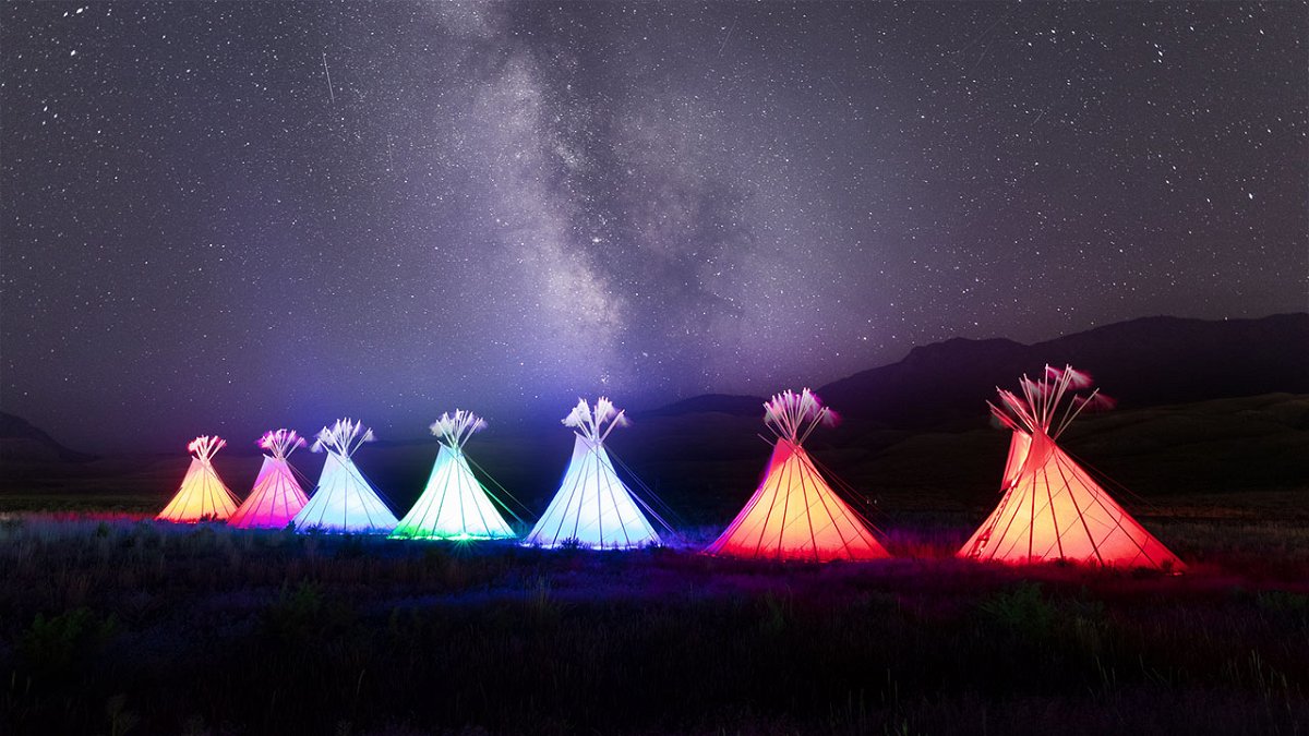 Illuminated teepees and Milky Way at North Entrance in Gardiner, Montana, 2022 