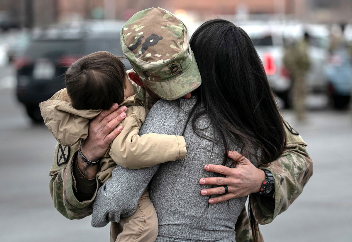 <i>John Moore/Getty Images</i><br/>U.S. Army SSG. Tyler Laliberte embraces his family after returning from a 9-month deployment to Afghanistan on December 10