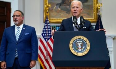 President Joe Biden (right) speaks in the Roosevelt Room of the White House on June 30 after Supreme Court rulings issuing a major decision that impacts gay rights and striking down Biden's student loan forgiveness plan. Education Secretary Miguel Cardona listens at left.