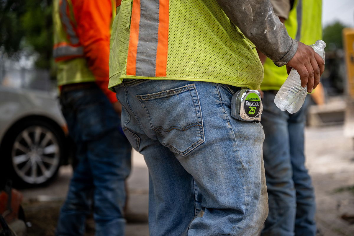 <i>Brandon Bell/Getty Images</i><br/>Construction workers gather together in the shade on July 11