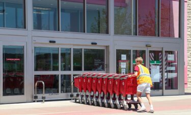 A Target employee returns shopping carts to the store at Monroe Marketplace in rural Pennsylvania in June 2021.