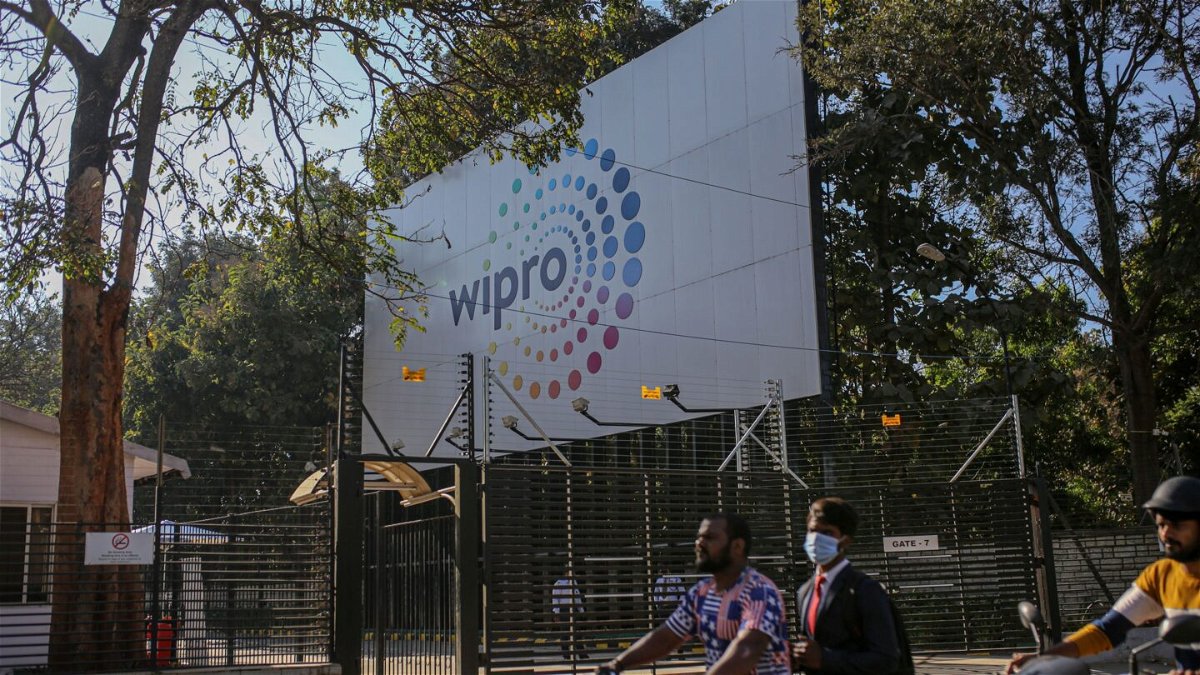 <i>Dhiraj Singh/Bloomberg/Getty Images</i><br/>Motorcyclists drive past a Wipro Ltd. sign in the Electronic City area of Bengaluru