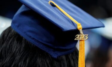A tassel with 2023 on it rests on a graduation cap as students walk in a procession for Howard University's commencement in Washington on May 13.