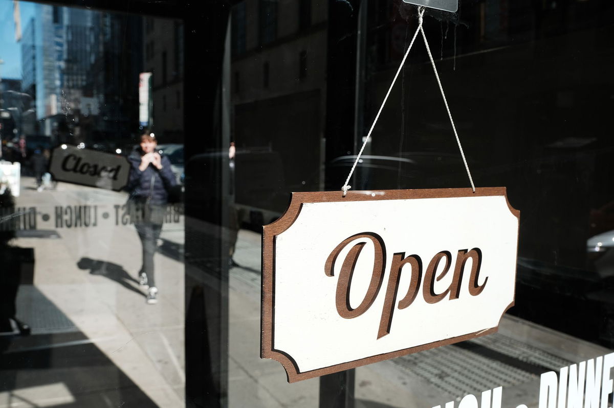 <i>Spencer Platt/Getty Images</i><br/>A store displays an 'open' sign along a street in Manhattan on February 14