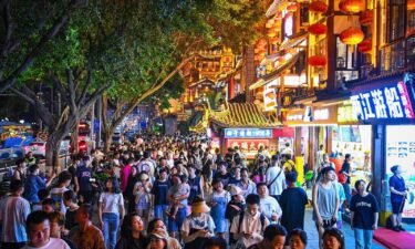 China has promised to support private businesses to boost economic growth. People here enjoy the night view of the Hongyadong scenic area in Chongqing