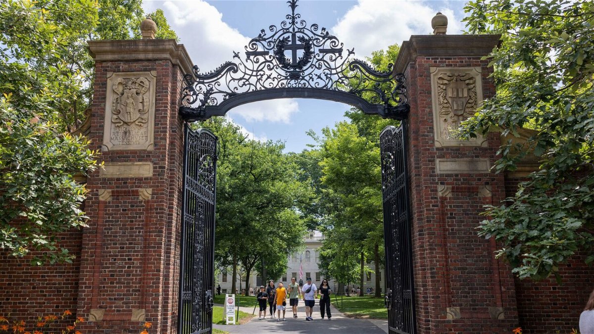 <i>Scott Eisen/Getty Images</i><br/>People walk through the gate on Harvard Yard at the Harvard University campus on June 29 in Cambridge