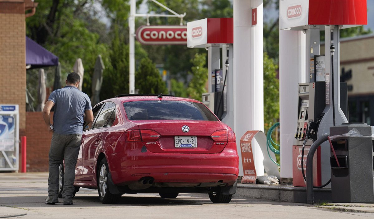 A motorist parks near the pumps at a service station Thursday, June 22, in Denver. US gas prices have climbed to an eight-month high.