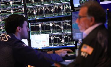 Traders work on the floor of the New York Stock Exchange during morning trading on July 06