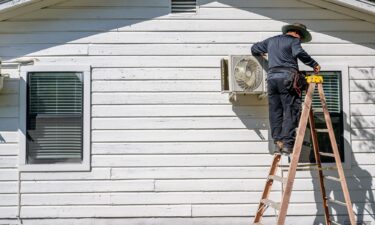 AC Tech Romero repairs an air conditioning unit on July 10 in Austin