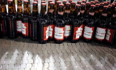 Bottles of beer move along a conveyor belt at the Anheuser-Busch InBev NV Budweiser bottling facility in St. Louis